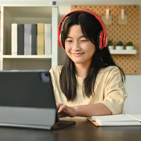 girl with headset looking the computer