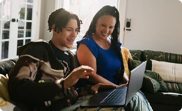 boy and woman looking the computer